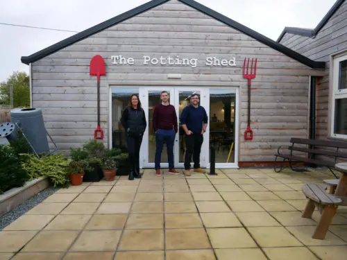 NAViGO Head of Commercial Services, Jo, Grimsby Garden Centre manager, Craig, and NAViGO Chief Executive, Simon standing outside of the Potting Shed